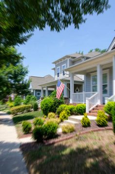 an american flag flying in front of a house