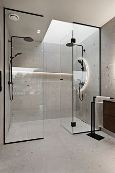 a bathroom with a walk in shower next to a sink and mirror on the wall