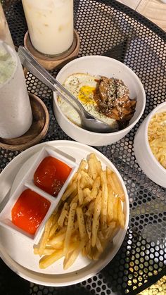 a table topped with plates of food next to glasses of milk and a glass of milk