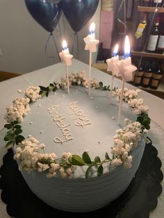 a birthday cake decorated with flowers and candles