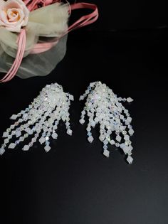 Elegant handmade earrings with Japanese crystals and glass beads. These earrings are special, the crystals cascade freely and are very bright. The earrings are white with crystal reflections. The earrings are clip-on, for those who do not have pierced ears and with a normal open hook, you can choose. They are very romantic and perfect for a beach bride. For those who love elegant and romantic style All jewels are delivered in a decorated box, ready to be given as a gift to your loved one. How to take care of your jewellery: put on your beauty products (cosmetics, perfumes, ...) before wearing your precious jewel. Clean your jewelry with a soft cloth after wearing. Don't use water. Make sure you store your jewelry separately to avoid scratching it. Store away from heat sources, in a dry pla White Crystal Drop Clip-on Earrings, White Dangle Clip-on Earrings For Party, White Crystal Clip-on Earrings For Party, White Crystal Clip-on Earrings For Gift, White Crystal Clip-on Earrings As Gift, Iridescent Dangle Earrings For Wedding, White Beaded Clip-on Earrings For Party, White Clip-on Bridal Earrings For Party, Crystal Fringe