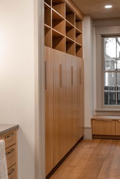 an empty room with wooden cabinets and white walls