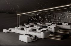 an empty movie theater with white seats and black walls