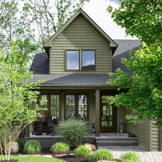 a house that has some plants in front of it