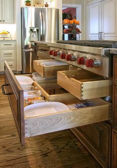 an open drawer in the middle of a kitchen