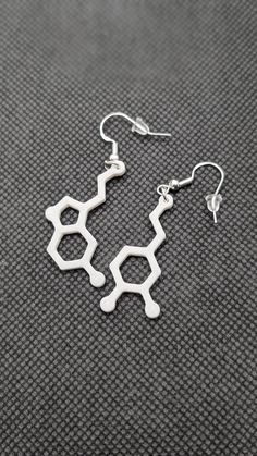 Add a touch of science to your style with our 3D-printed Serotonin and Dopamine Earring Set! These lightweight earrings, standing at 1 1/4" tall, are available in bold colors like white, black, blue, pink, orange, and green. Perfect for anyone who loves unique, chemistry-inspired accessories, these earrings are a fun way to show off your love for brain chemistry while staying on-trend. Ideal for gifting or personal wear, they are an exciting blend of modern fashion and scientific flair. Shop now for your custom Serotonin and Dopamine earrings! ** The earrings in the photo are shown in jade white ** Select the color you want when checking out! Science Fashion, Brain Chemistry, Orange And Green, Earrings Unique, Lightweight Earrings, Light Weight Earrings, North East, Modern Fashion, Unique Earrings