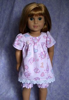 the doll is wearing a pink dress and shoes