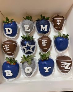 chocolate covered strawberries are arranged in the shape of footballs and stars with letters on them