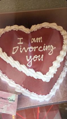 a heart shaped cake with the words i am divoring you written on it