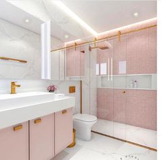 a bathroom with pink and gold accents