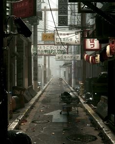 an alley way with many signs on the buildings