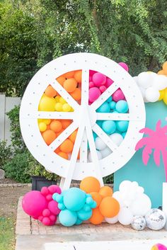 White ferris wheel prop for backdrop with pink, blue, orange, white and yellow balloons. Disco ball accents and palm tree props, festival backdrop, palm tree prop, ferris wheel prop, ferris wheel backdrop, balloon garland, festival birthday party, festival theme, boho festival, festival birthday, sweet 16 birthday, 16th birthday ideas, sweet 16, scottsdale arizona Coachella Birthday Party, Coachella Party Theme, Coachella Theme, Coachella Birthday, Tree Props, Coachella Party, Sweet 16 Party, Hawaii Party, Party Printables Free