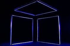 an open door in the dark with blue light coming from it's center and sides