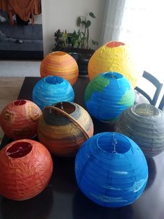 many different colored vases sitting on a table