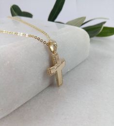 "A fine cross in K14 made of yellow solid gold. It's a simple cross that is decorated with small zircons creating four right angles (on the top, on the bottom on the right and left side of the cross). A simple, minimal, inter temporal cross. Ideal for a present, engagement gift, anniversary and baptism. It is one of the most beautiful designs and can easily be worn by a woman of any age, who likes minimal design. The dimensions of the cross are: Height 1,26 inches (3,2 cm.) Width 0,71 inches (1, Gold Cubic Zirconia Cross Necklace, Gold Cubic Zirconia Pendant Cross Necklace, Yellow Gold Cubic Zirconia Cross Necklace, 14k Gold Cross Necklace For First Communion, Yellow Gold Cross Necklaces For Baptism, Yellow Gold Cross Pendant For First Communion, Gold Cross Pendant Jewelry For Baptism, Yellow Gold Cross Pendant Necklace For First Communion, Yellow Gold Cross Pendant For Baptism