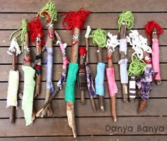 there are many different types of toothbrushes on the wooden table with writing underneath them