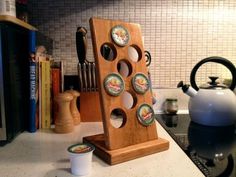 a kitchen counter with a tea kettle and various cooking utensils on it