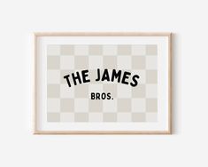 the james bros logo in black and white on a beige checkered background, framed in a wooden frame