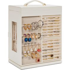 a white jewelry box filled with lots of earrings