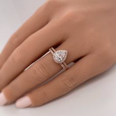 a woman's hand with a diamond ring on it