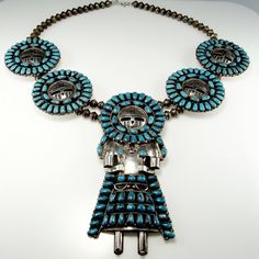 An astonishing natural turquoise ceremonial necklace dating to the mid century era. This piece is signed BY on the reverse. It has been professionally tested and is sterling silver. This necklace is monumental. Just the central Kachina alone measures 5" long by 2 1/4" wide with the other Kachina face turquoise elements each measuring 2" in diameter. The necklace is entirely handmade. It measures 20 7/8" long around the neck. In total this astonishing necklace weighs 203 grams. This piece is in g Cabochon Necklace, Indian Necklace, Native American Artists, Native American Indians, American Indian, Natural Turquoise, Native American Jewelry, Boho Necklace, Boho Bohemian