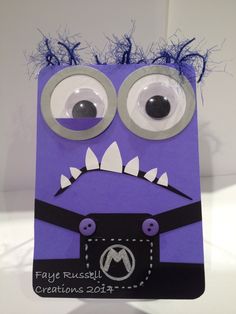 a purple card with googly eyes and an eyeball in the shape of a monster