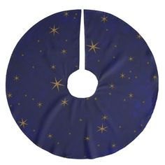 a blue and gold christmas tree skirt with golden stars on the bottom, hanging from a hook