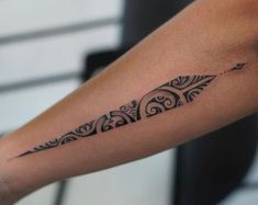 a black and white tattoo design on the arm