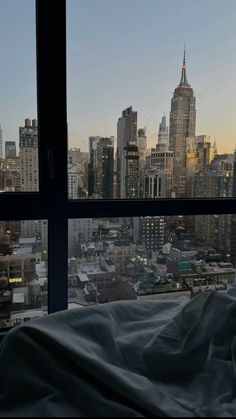 a view of the city from a bedroom window