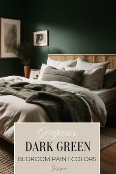 a bedroom with dark green walls and white bedding