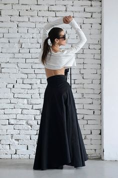 Extravagant two length black maxi skirt - METSk0004  A gorgeous black skirt is always welcome in anyone’s wardrobe. The silhouette of this piece is created with the idea of a fashionable and yet comfortable look that a 21 century woman should have. I have chosen a modern shape of a shorter front side and a classic long back, making the skirt very elegant and super practical at the same time. The beauty of this piece is that it can be worn in many occasions and by everyone no matter what age y... Black Baggy Maxi Skirt For Spring, Baggy Black Maxi Skirt For Spring, Black Baggy Long Skirt, Black Wide-leg Maxi Skirt, Black Loose Fit Wide Leg Maxi Skirt, Black Long Skirt With Voluminous Fit, Black Maxi Dress With Full Skirt For Evening, Black Voluminous Long Skirt, Black Asymmetrical Voluminous Maxi Skirt