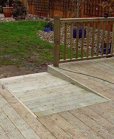 a wooden deck in the middle of a yard