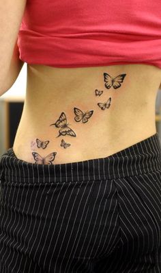 a woman's stomach with butterflies on her lower body and the bottom part of her abdomen