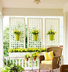 the porch is decorated with wicker furniture and potted plants