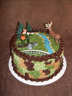 there is a cake decorated with animals and trees