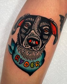 a dog with a bandana on it's head is shown in this tattoo