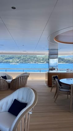 the interior of a boat with wooden floors and white furniture on it's deck