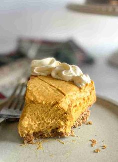 a slice of pumpkin cheesecake on a plate with a fork