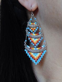 These gorgeous earrings were hand beaded in Peru. They measure 3 inches in length, 1 inch in width, with surgical steel ear wires. Bohemian Beaded Chain Dangle Chandelier Earrings, Bohemian Beaded Chandelier Dangle Earrings, Southwestern Beaded Drop Earrings For Pierced Ears, Dangle Beaded Earrings For Festivals With Ear Wire, Dangle Beaded Earrings With Ear Wire For Festivals, Festival Dangle Beaded Earrings With Ear Wire, Dangle Beaded Earrings For Festivals, Southwestern Style Beaded Drop Earrings, Festival Beaded Dangle Chandelier Earrings