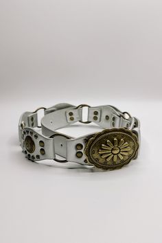 The Bianca Studded Floral Buckle Belt brings a bold statement to your style. Made from premium faux-leather, this belt is available in silver, black, or brown, offering options for any look. Featuring antiqued gold links and stud details, it adds an edge to your ensemble while maintaining a chic, feminine vibe. The standout feature is the floral detailed buckle, which adds a touch of charm to the belt’s bold design. Perfect for pairing with jeans or dresses, the Bianca belt effortlessly blends e Chic Adjustable Belt With Antique Buckle, Chic Adjustable Belts With Antique Buckle, Trendy Silver Belt Buckle With Belt Included, Adjustable Silver Belt For Festival, Adjustable Silver Belt, Adjustable Silver Belt With Buckle Closure, Vintage Adjustable Metal Belt, Chic Adjustable Belts For Festivals, Silver Adjustable Belt With Antique Buckle