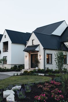 a white house with black roof and windows