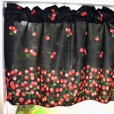 the curtain is decorated with cherries and black fabric