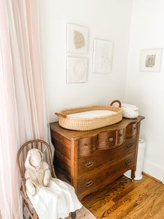 a baby's crib in the corner of a room next to a dresser