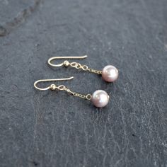 Very pretty light purple/pinkish colored freshwater pearls dangle gently from your choice of sterling silver or gold fill chain and hooks. This material will not tarnish and can even get wet! Pearls are near round and approximately 8mm in size. Very popular and pretty color!! Click here for a complimenting necklace! https://www.etsy.com/listing/613385861/dainty-three-pearl-necklace-with-8mm Delicate Pink Dangle Pearl Earrings, Dainty Pink Pearl Drop Earrings, Pink Dangle Pearl Chain Jewelry, Pink Dainty Dangle Pearl Earrings, Pink Pearl Charm Earrings For Gift, Gift Pink Pearl Charm Earrings, Three Pearl Necklace, Hair Accessories Collection, Pearl Bangle