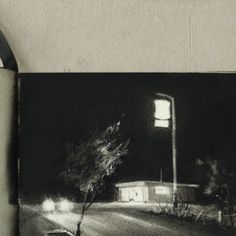 a black and white photo of a street at night