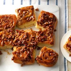 several pieces of cinnamon rolls on a white plate