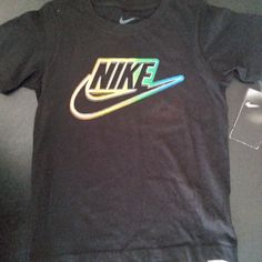 Get Your Little Boy Ready For Any Activity With This Nike Boys Size 6 Neon Logo Black Tee. The Shirt Features A Crew Neck Design And Pullover Closure For Easy Wear, Making It Perfect For Casual And Activewear Occasions. The Short Sleeve Shirt Is Made Of A Cotton Blend Material That Is Easy To Care For And Suitable For All Seasons. In Addition To Its Comfort And Style, This Shirt Also Showcases The Nike Logo And Comes In A Bold Green Color. It's A Great Addition To Any Young Boy's Wardrobe And Pe Nike Multicolor Sports Tops, Nike Multicolor Tops For Streetwear, Nike Multicolor Short Sleeve T-shirt, Nike Multicolor Graphic Print T-shirt, Nike Long Sleeve Shirt, Tops Nike, Neon Logo, Nike Boys, Nike Long Sleeve