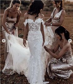 bridesmaids in gold and white gowns standing around each other