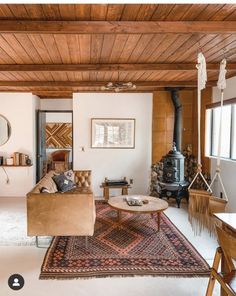 a living room filled with furniture and a fire place in the middle of a room