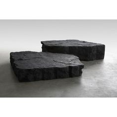 two black rocks sitting on top of each other